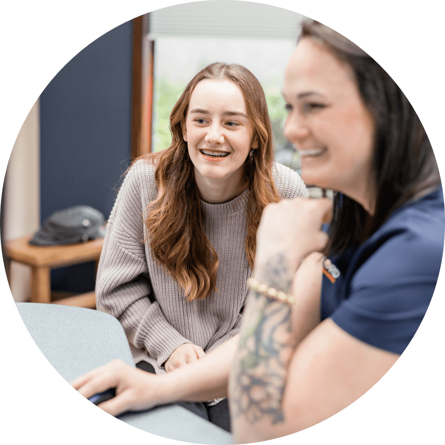 teen patient and team member smiling during appointment